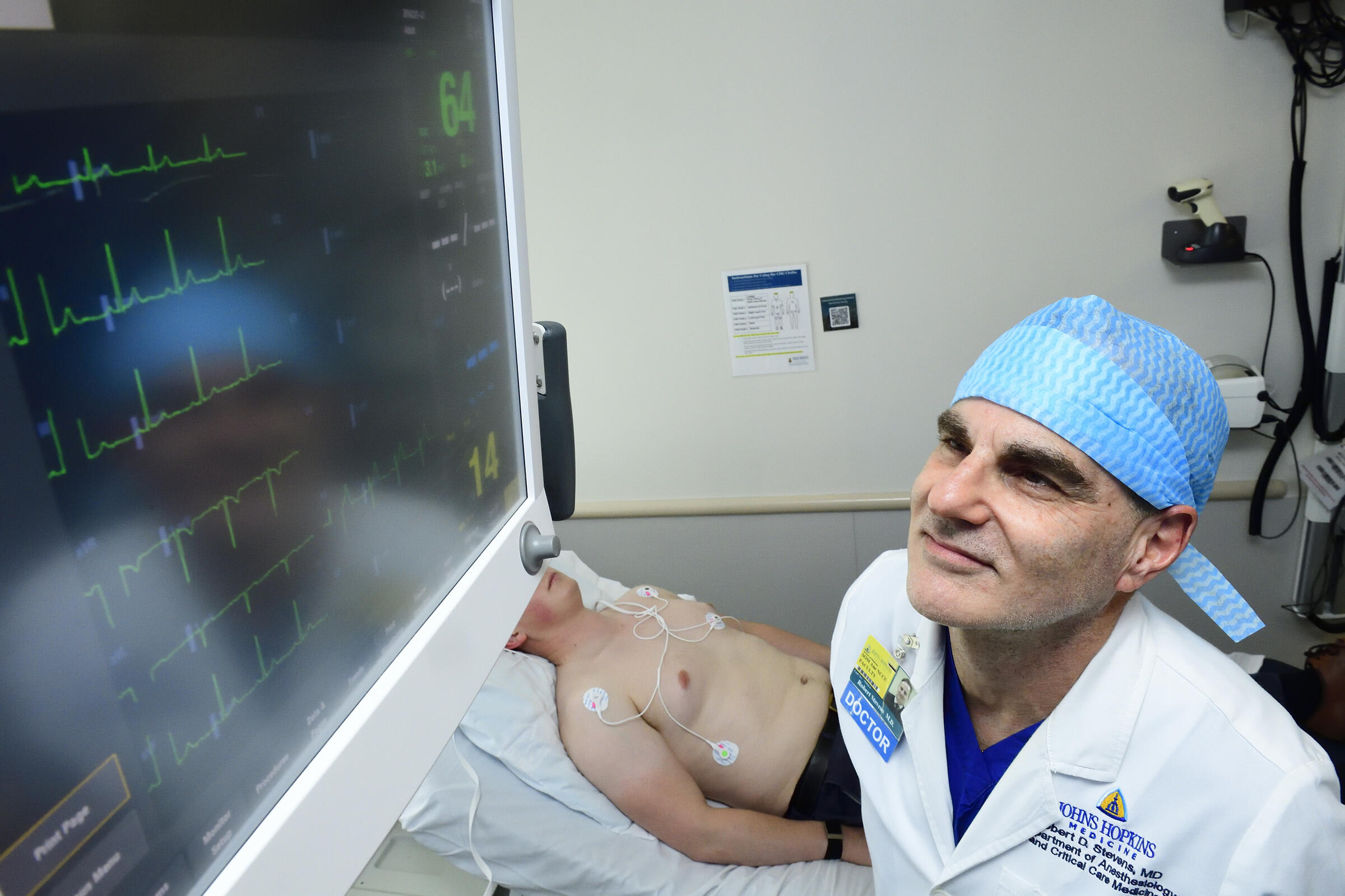 Robert Stevens observes an electrocardiogram monitor
